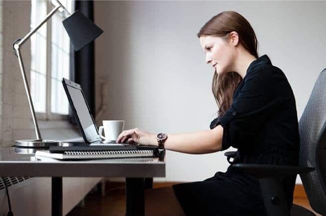 photo-of-woman-sat-at-desk-using-laptop-suggesting-student-of-an-online-course