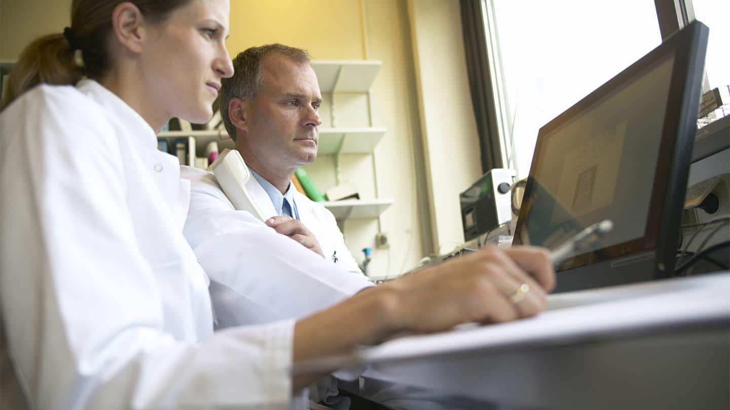 man-and-woman-in-lab-coats-looking-at-a-computer-suggests-considering-how-long-a-career-change-to-pharmaceutical-manufacturing-will-take