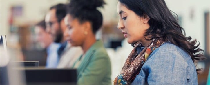 photo-showing-line-of-people-sitting-at-computers-to-suggest-successfully-returning-to-education-with-online-course