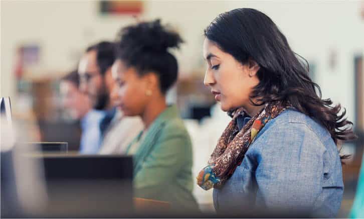 photo-showing-line-of-people-sitting-at-computers-to-suggest-successfully-returning-to-education-with-online-course