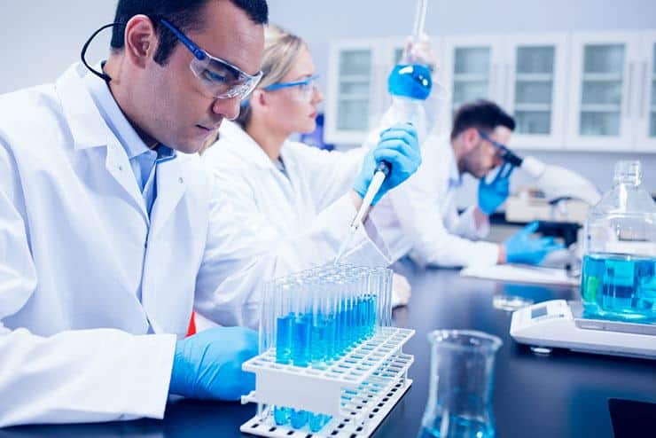 three-biochemists-conducting-experiments-in-pharmaceutical-laboratory