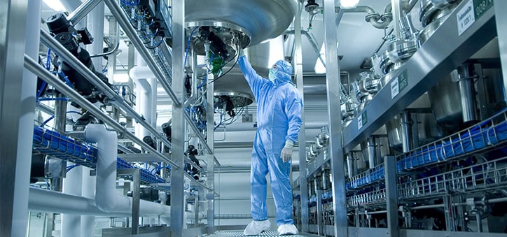 working-at-sandoz-getreskilled man in protective clothing operating manufacturing equipment