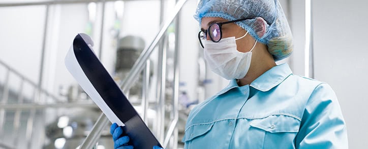 CQV Engineer checking a validation protocol in a pharmaceutical manufacturing plant.